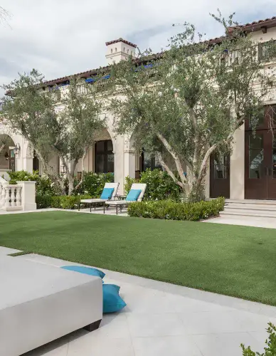 Rectangular garden pool leading toward a mature tree and lawn